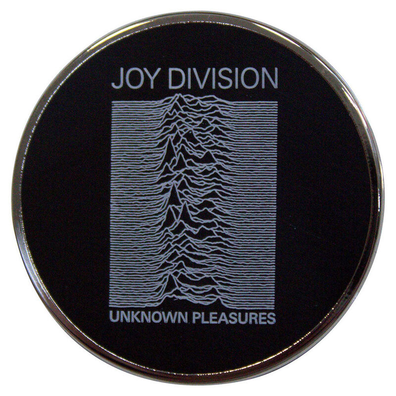 Round black metal pin with the Unknown Pleasures pulse graphic, a silver rim and small album lettering