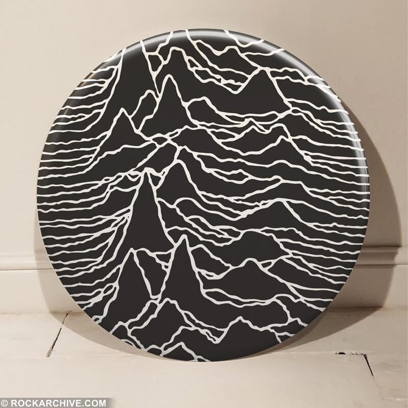 Tony Dennis’s giant round wall badge with an enlarged crop of the Unknown Pleasures pulse graphic