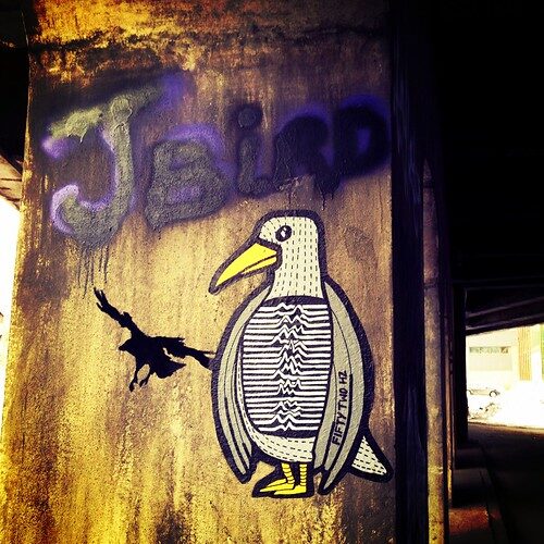 Unknown Pleasures penguin paste-up in Montréal — reference image from Flickr