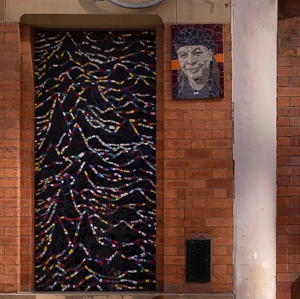 Mark Kennedy’s tiled mosaic of the Unknown Pleasures cover on an exterior wall at Afflecks in Manchester