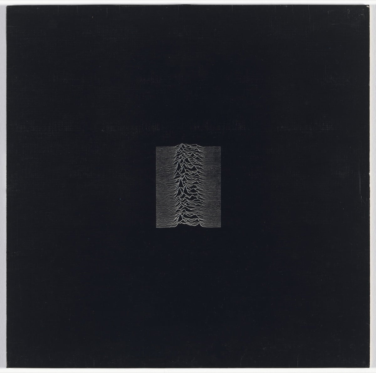 The original Unknown Pleasures album sleeve: white stacked pulse lines on a black square